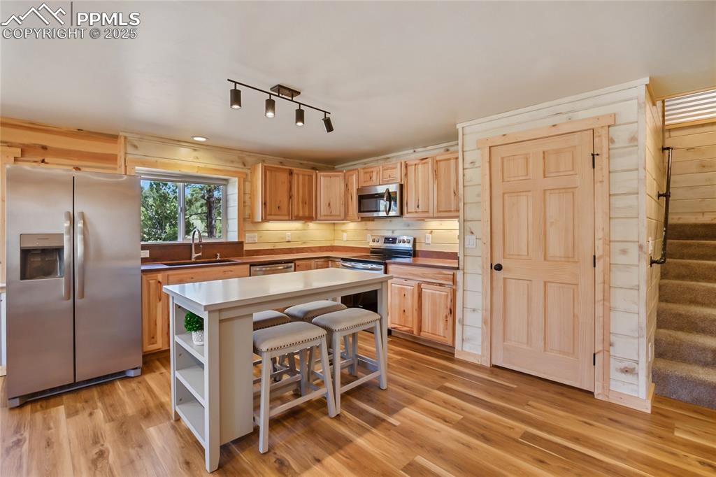 Image 13 of 45: Kitchen has beautiful hickory cabinet