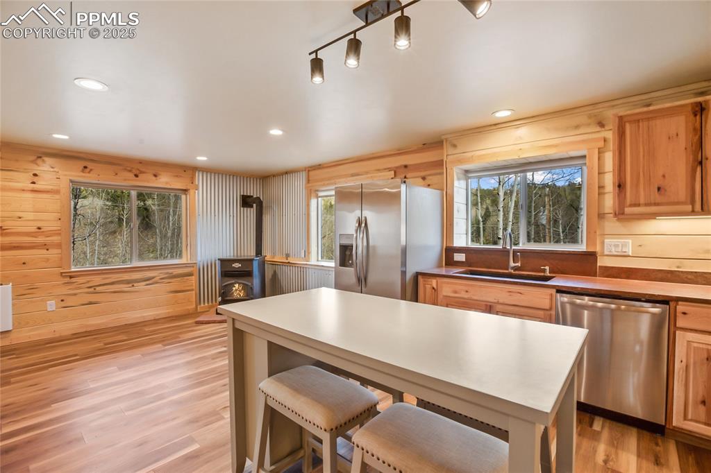 Image 15 of 45: Kitchen countertops have beautiful leathered granite countertops and recess
