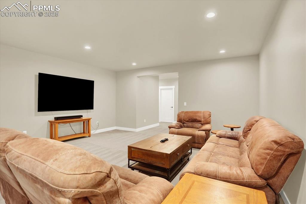 Image 31 of 50: Living area featuring recessed lighting and carpet flooring