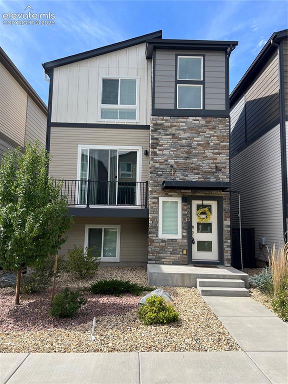 Image 1 of 35: Multi-level exterior featuring stone veneer and siding, a front entry with