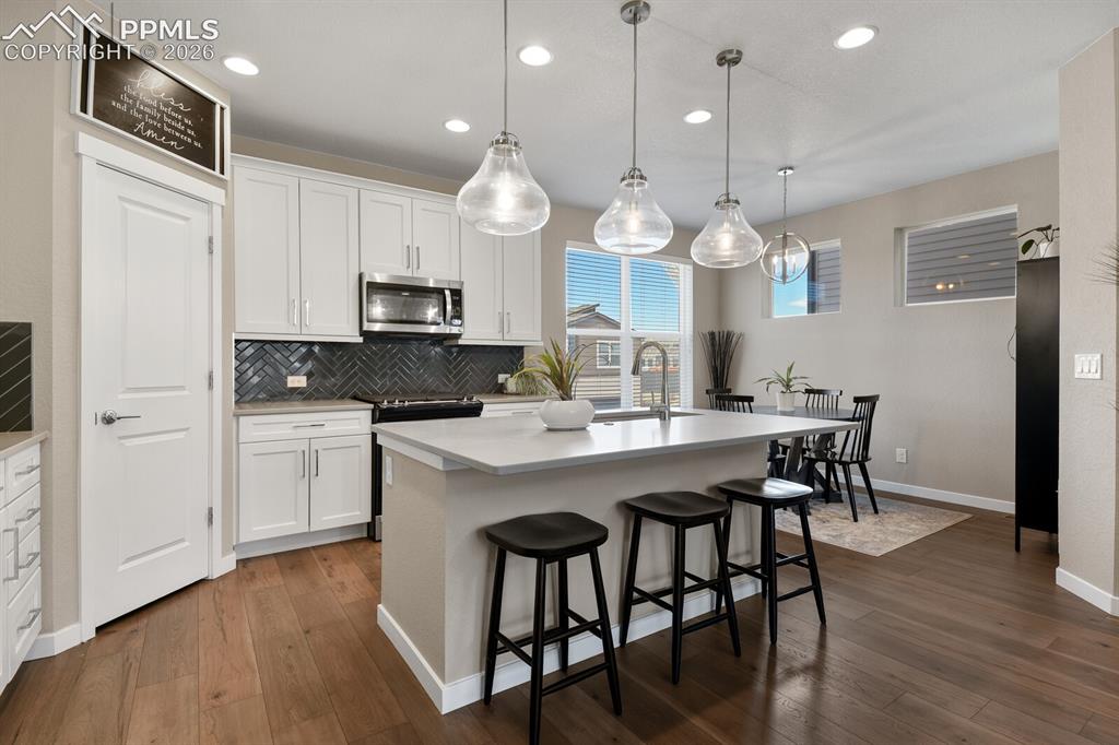 Image 11 of 35: Gorgeous Backsplash Tile & Bar With Quartz Countertop