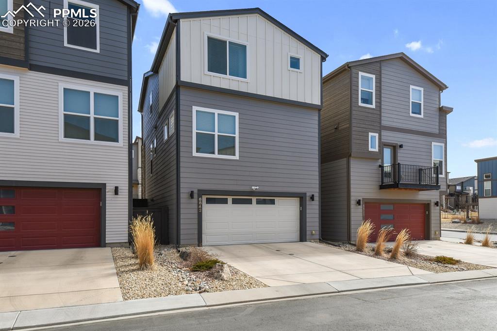 Image 29 of 34: Back of Home with 2-Car Garage