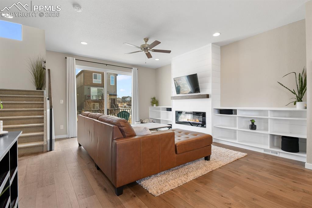 Image 8 of 35: Great Room with Built-In Fireplace & Bookcases