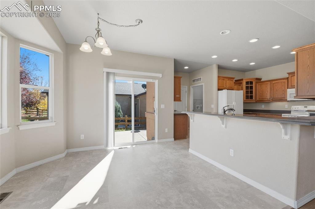 Image 10 of 46: Walk out Nook and View of kitchen