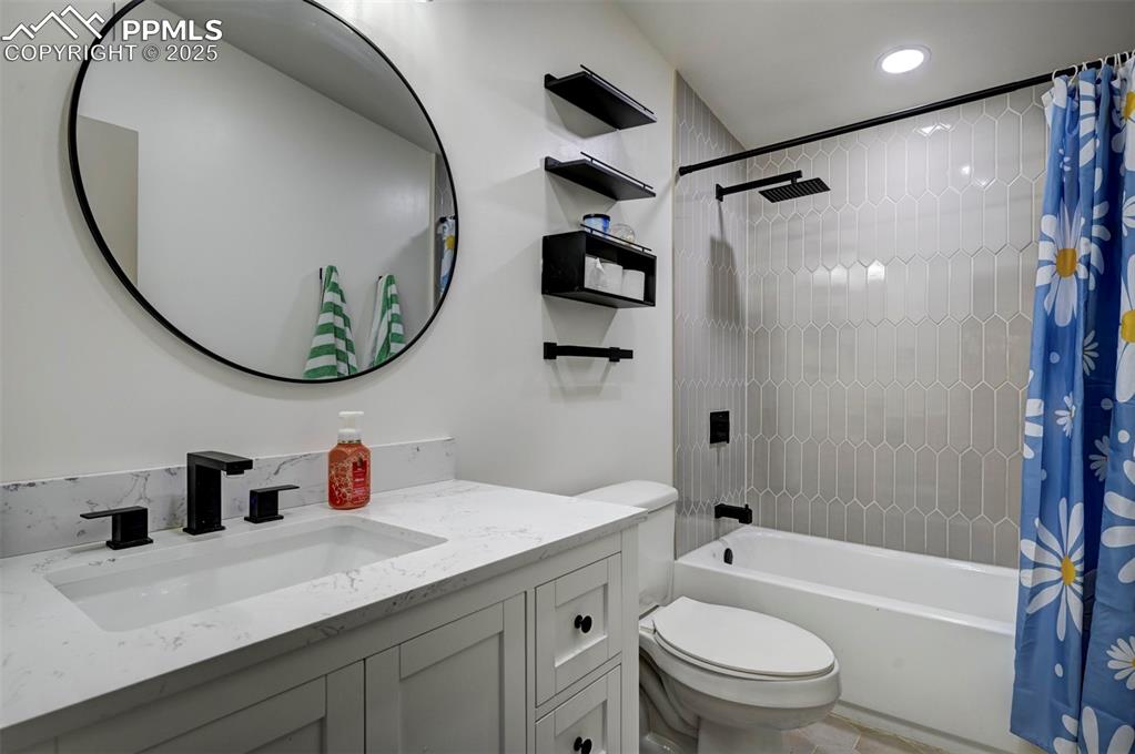 Image 21 of 40: Bathroom featuring shower / bath combo and vanity