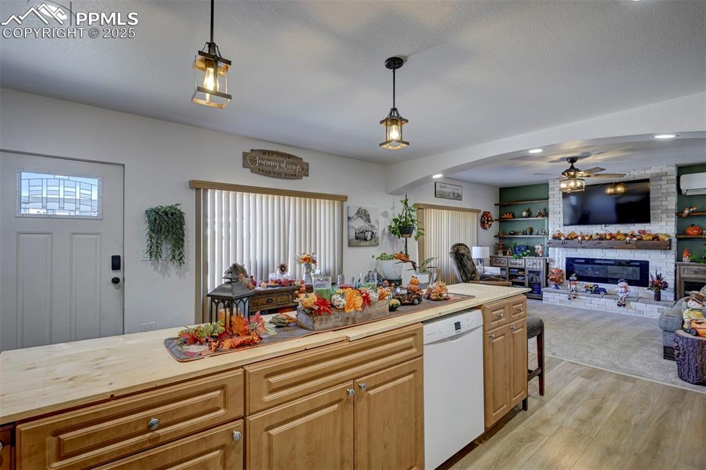 Image 27 of 40: Kitchen with recessed lighting, light wood finished floors, dishwasher, a b