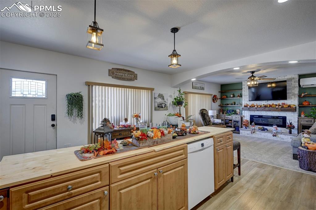 Image 29 of 40: Kitchen with recessed lighting, dishwasher, light wood-type flooring, a bri