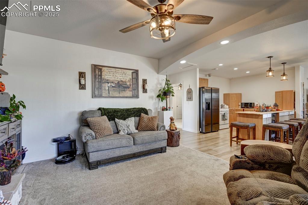 Image 32 of 40: Living area featuring recessed lighting, a ceiling fan, light wood-type flo