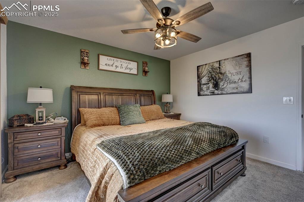 Image 33 of 40: Carpeted bedroom with baseboards and ceiling fan