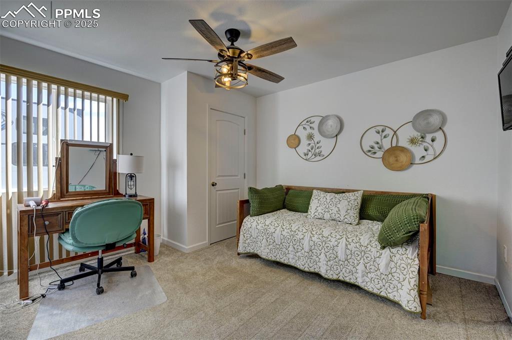 Image 36 of 40: Office area with carpet and a ceiling fan