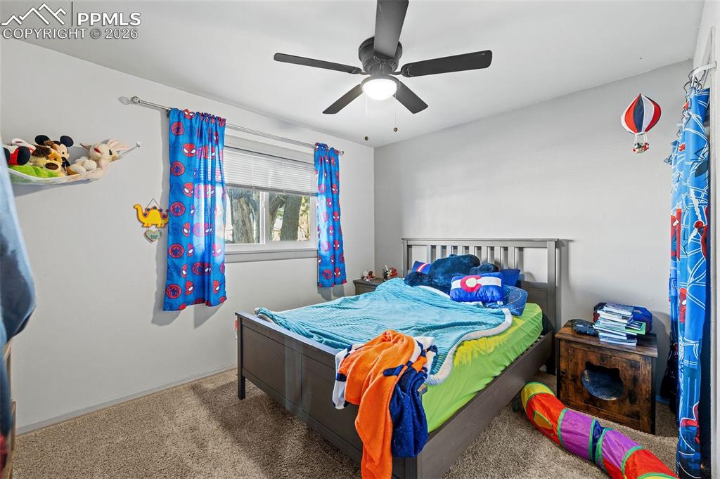 Image 15 of 19: Carpeted bedroom featuring ceiling fan