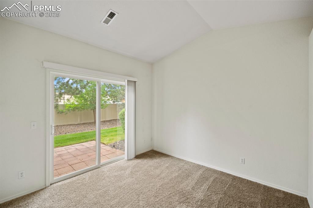 Image 13 of 22: Carpeted spare room with lofted ceiling and baseboards