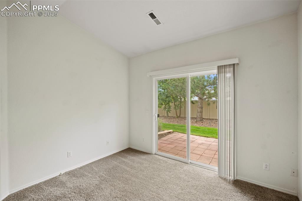 Image 14 of 22: Carpeted spare room featuring lofted ceiling and baseboards