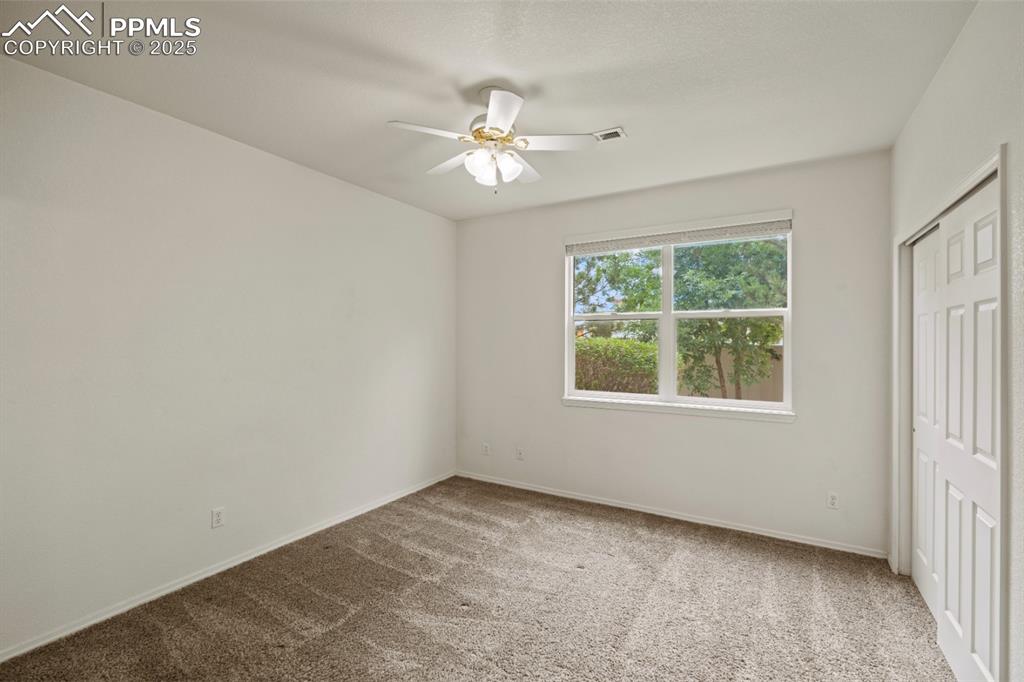 Image 17 of 22: Unfurnished bedroom with carpet flooring, a ceiling fan, and a closet