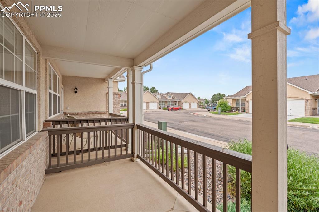 Image 19 of 22: Covered porch with a residential view
