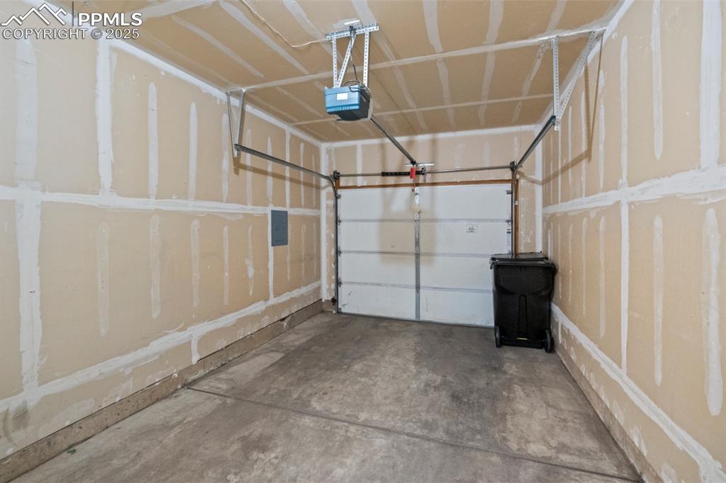 Image 20 of 22: Garage featuring a garage door opener