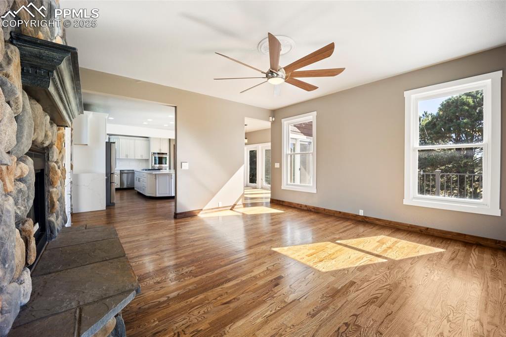 Image 13 of 50: Unfurnished living room with dark wood-type flooring, a fireplace, and a ce