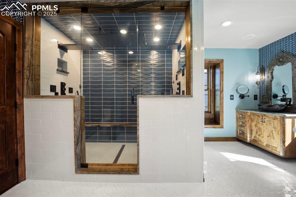 Image 26 of 50: Full bath featuring a shower stall, vanity, and recessed lighting