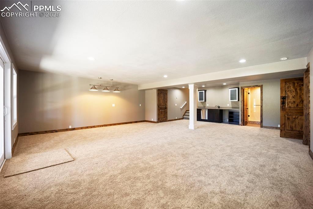 Image 29 of 50: Spare room with light colored carpet and recessed lighting