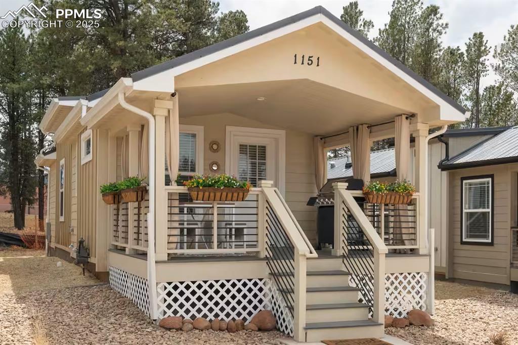 Caption: View of front of home with covered porch