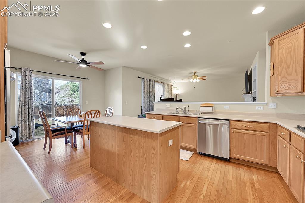Image 10 of 44: Kitchen featuring recessed lighting, stainless steel dishwasher, light coun