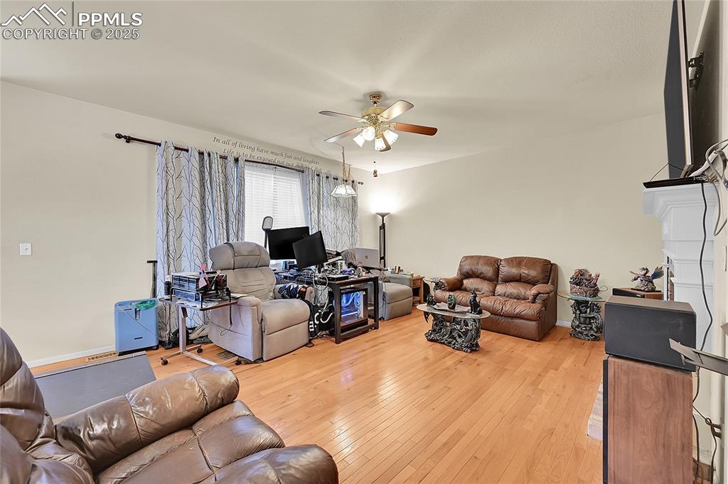 Image 17 of 44: Living room featuring light wood-type flooring and ceiling fan