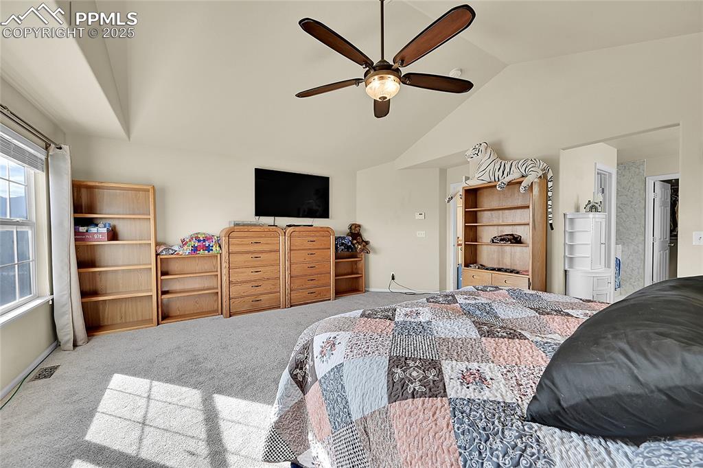 Image 22 of 44: Bedroom with carpet flooring, lofted ceiling, and a ceiling fan