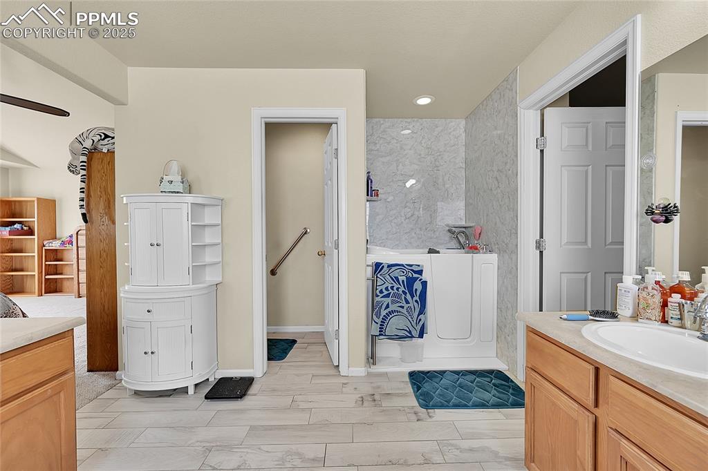 Image 24 of 44: Bathroom with vanity, wood finish floors, and recessed lighting