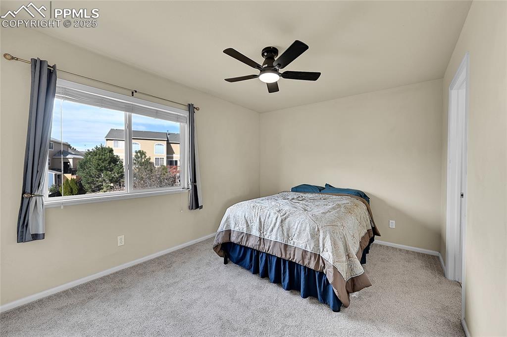 Image 26 of 44: Carpeted bedroom featuring baseboards and ceiling fan