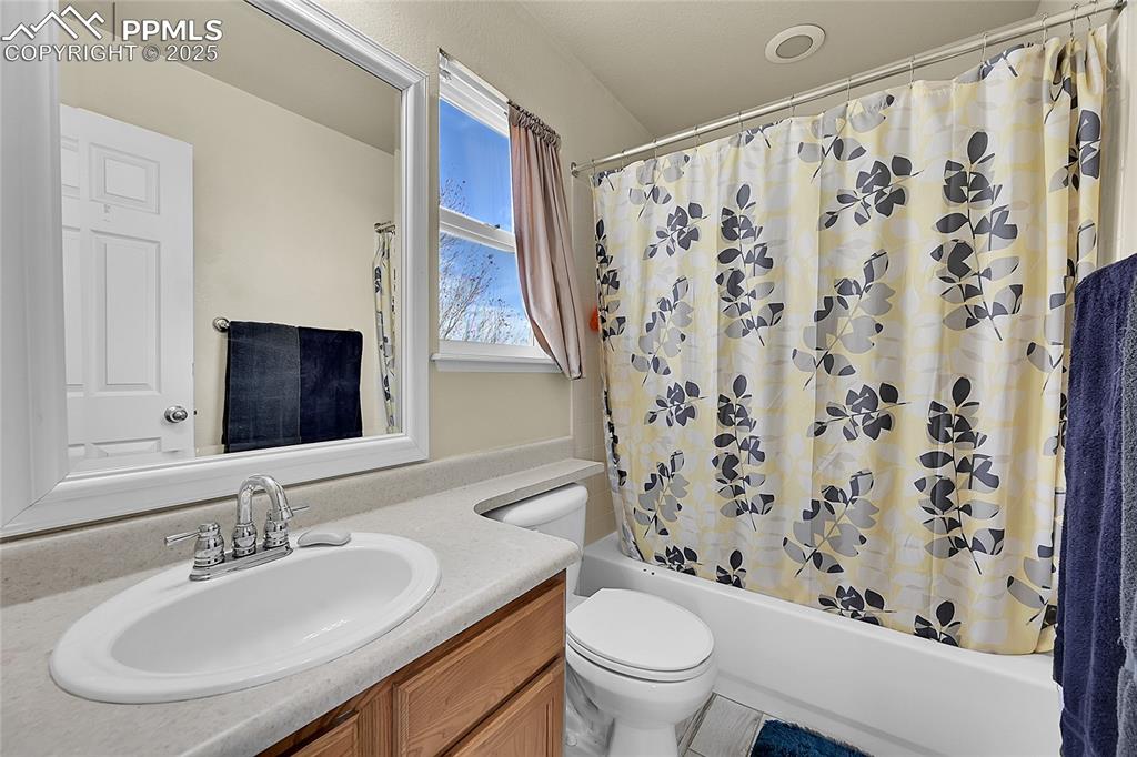 Image 27 of 44: Full bathroom featuring shower / bathtub combination with curtain and vanit