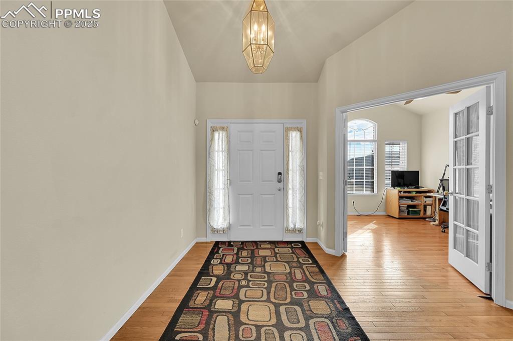 Image 4 of 44: Entrance foyer with light wood-type flooring and a chandelier