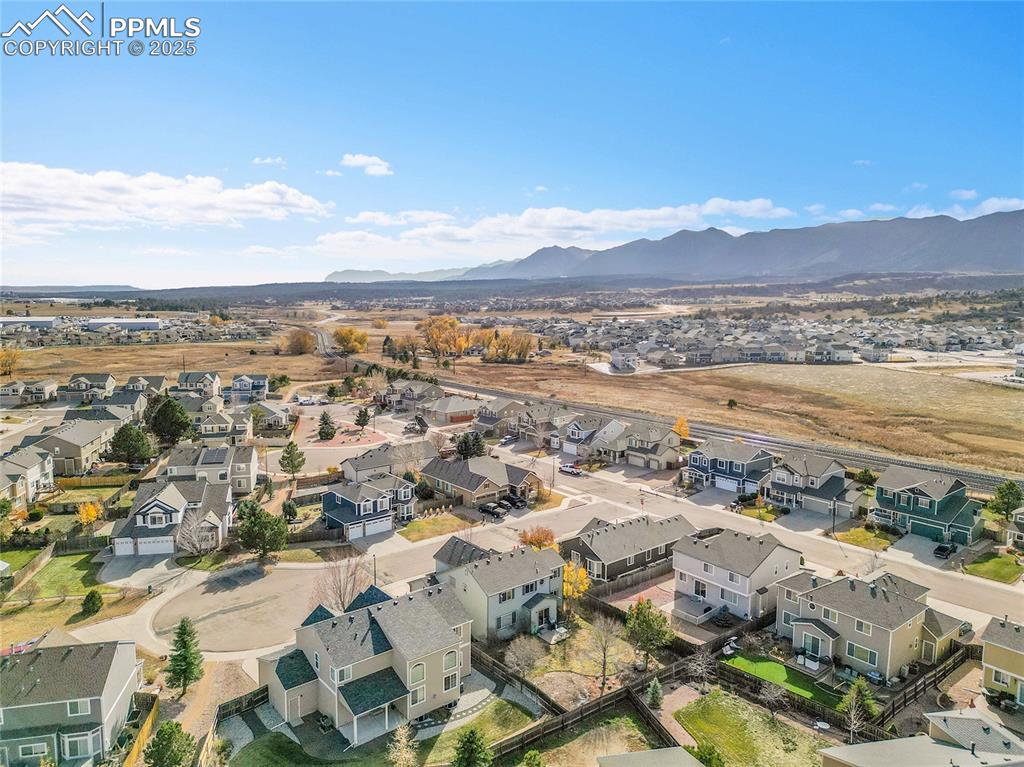 Image 41 of 44: Aerial perspective of suburban area with mountains