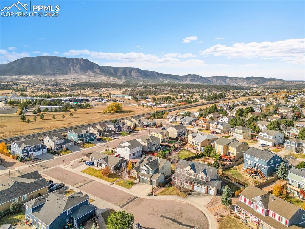 Image 42 of 44: Aerial perspective of suburban area featuring mountains