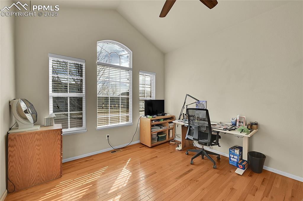 Image 5 of 44: Office area with vaulted ceiling, light wood-type flooring, and a ceiling f