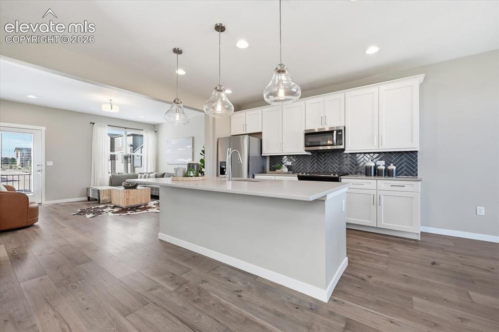 Image 10 of 25: Large kitchen with upgraded appliances and gas range! White cabinets!