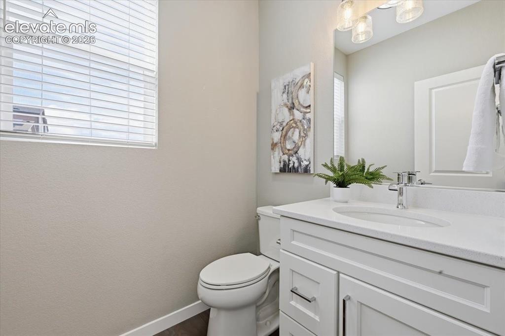 Image 14 of 25: Powder bath on the main level with quartz counters!