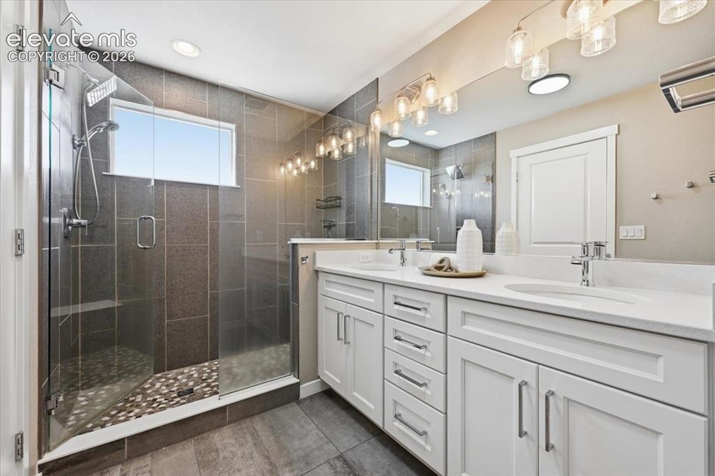 Image 19 of 25: Spacious master bath with double vanity and white cabinets!