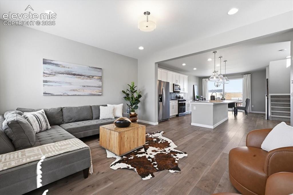 Image 6 of 25: Open concept to kitchen and dining room!