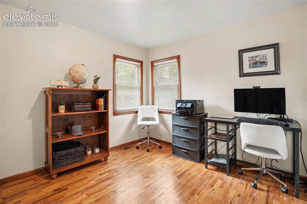 Image 13 of 24: This bedroom is currently being used as an office, but has its own closet.