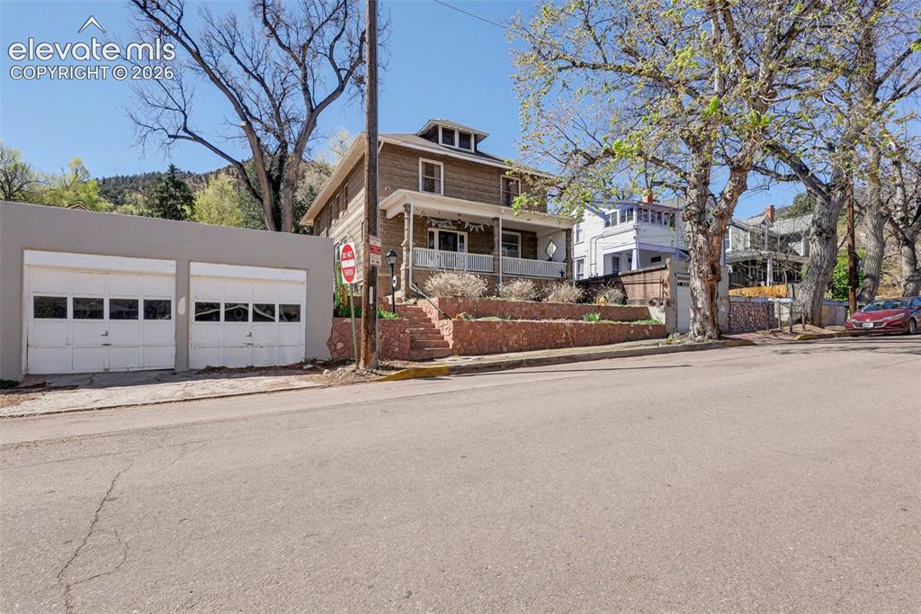 Image 8 of 43: Front view of main home and 2 car detached garage