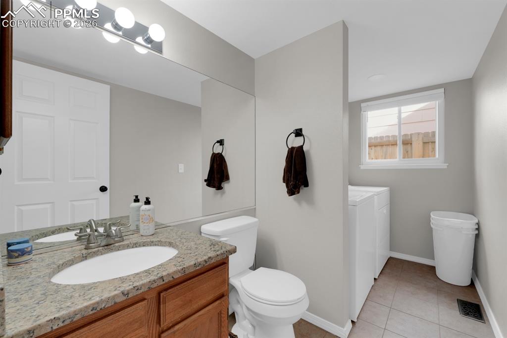 Image 14 of 39: Half bath on main level with laundry