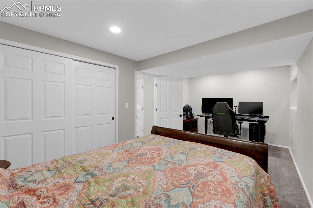 Image 29 of 39: Carpeted bedroom with a closet and a desk