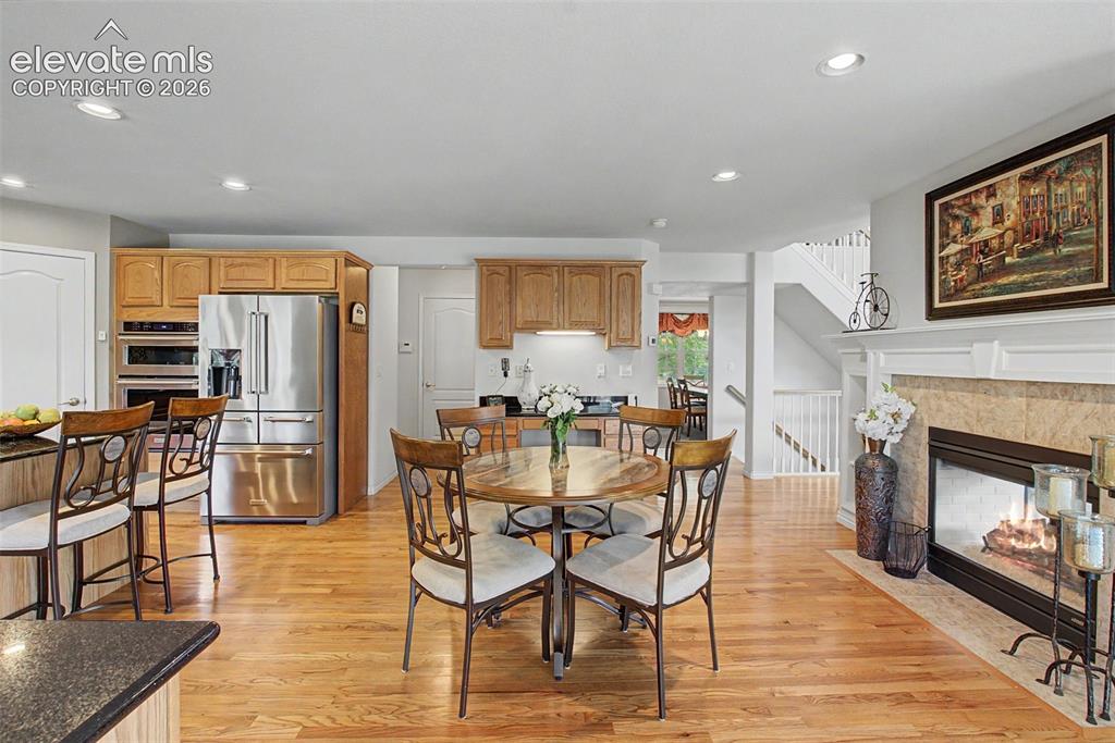 Image 12 of 50: Warm and Inviting Breakfast Nook with Dual Sided Gas Fireplace Boasting Bui