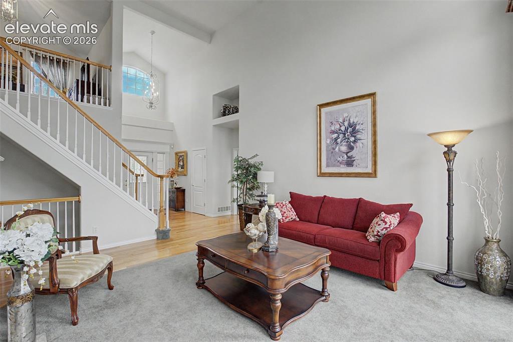 Image 19 of 50: Formal Living Room with 2 Story Ceiling!