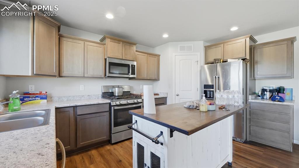 Image 15 of 36: The Kitchen offers a wood cabinets with solid surface countertops, a pantry