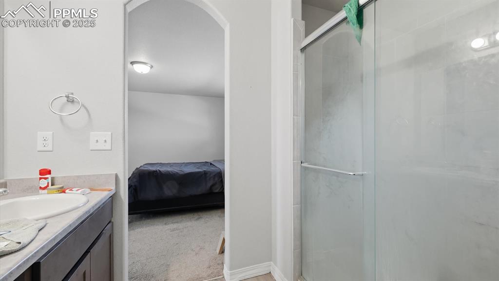 Image 19 of 36: View of the Primary Bedroom from the Primary Bathroom.