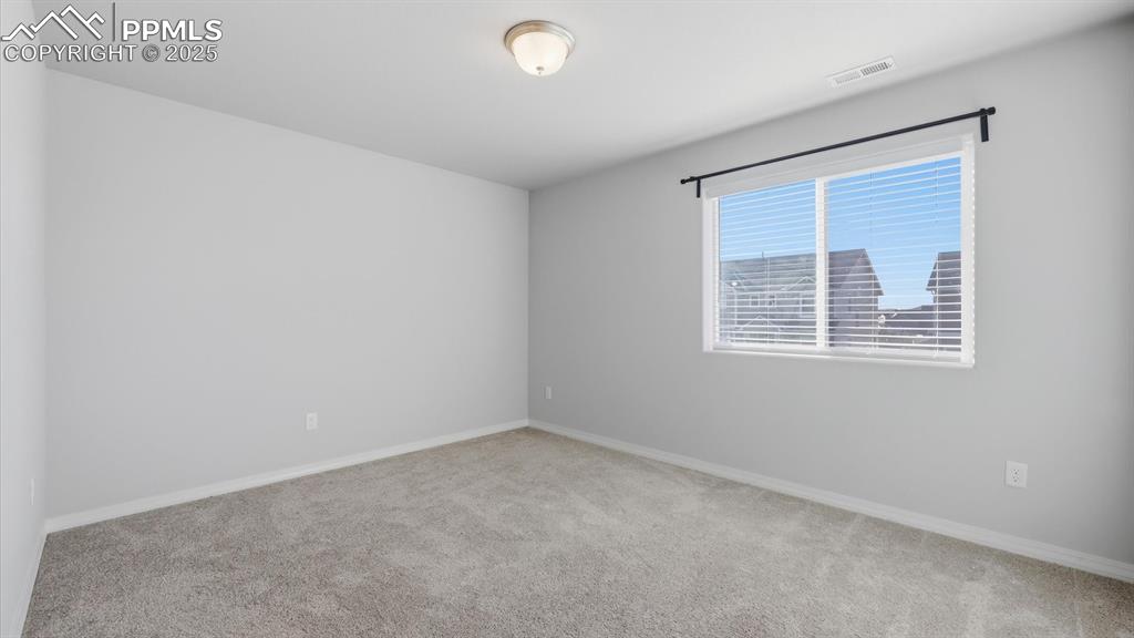 Image 22 of 36: Bedroom #2 with neutral carpet.