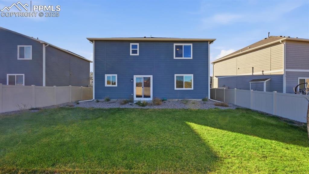 Image 28 of 36: Fenced level backyard.