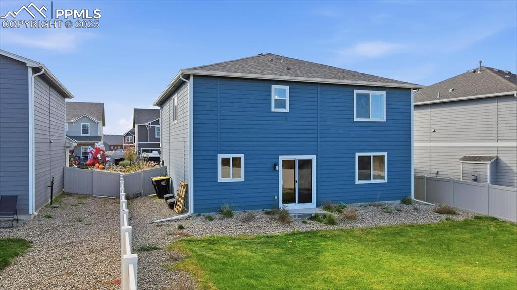 Image 29 of 36: Low maintenance backyard with rock beds and side yard.