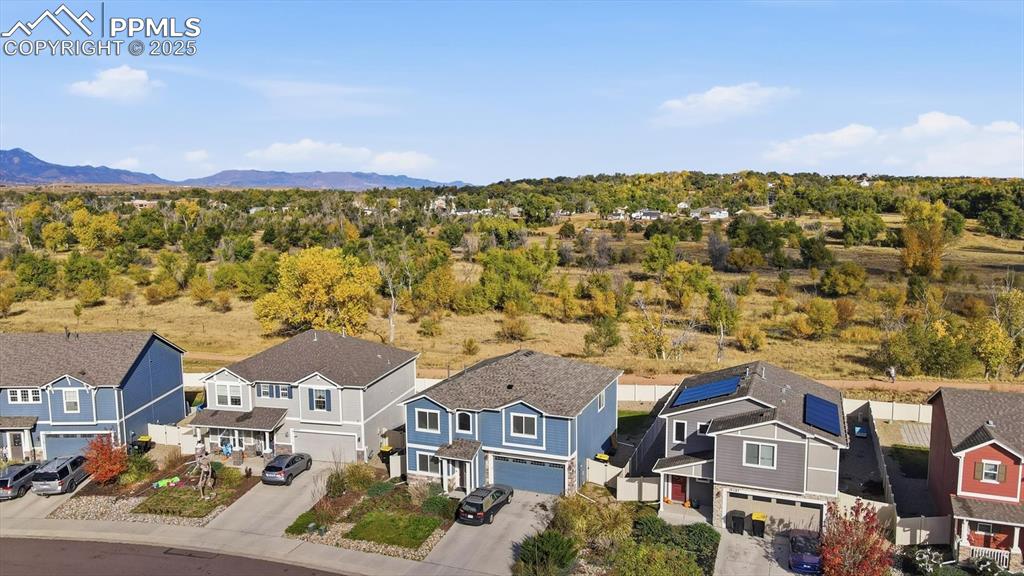 Image 3 of 36: Aerial view of home and open space with trails.